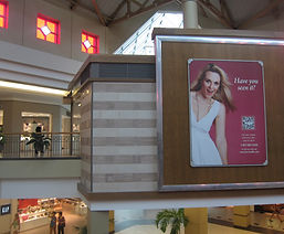 Trade show ad with smiling woman in white dress, 'Have you seen it?'