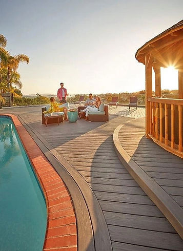 Modern pool deck with curved railings and a gazebo.