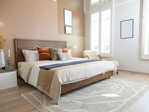 Bedroom with a large bed and light peach painted walls