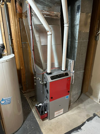 Modern furnace unit with red front panel and piping