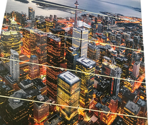 Cityscape at night with illuminated buildings and CN Tower