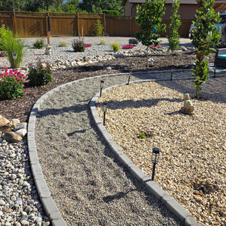 Curved gravel path in a landscaped backyard project.