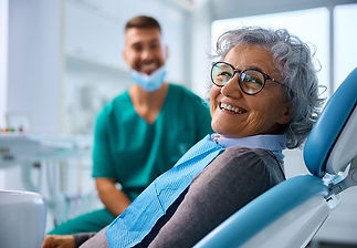 Smiling senior patient in a restorative dentistry chair