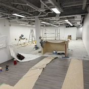 Interior renovation: Construction tools and materials throughout an empty commercial space.