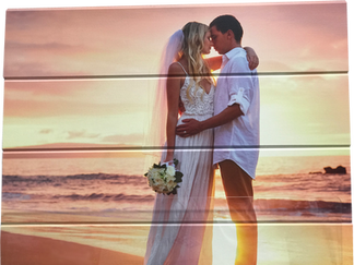 Wedding couple kissing on beach at sunset