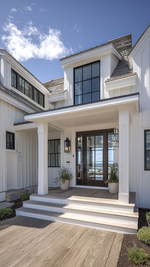 Modern home exterior with white siding and glass front door.