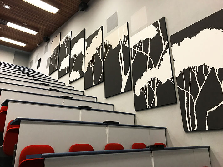 Black and white tree art panels in a lecture hall