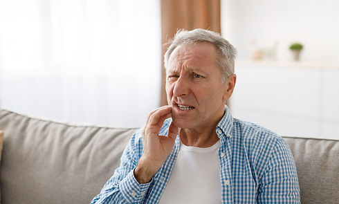 unhappy mature man suffering from terrible toothache
