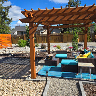 Wooden pergola over a patio with blue outdoor furniture.