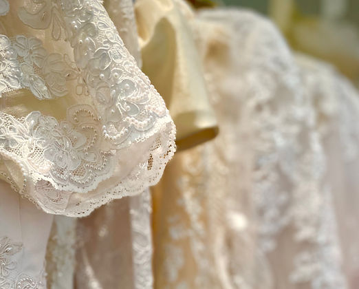 Close up photo of wedding dress sleeves with lace and beads