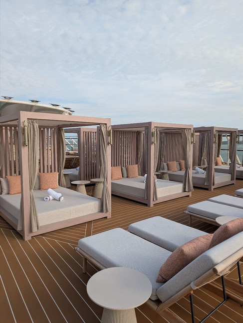 Private cabanas and lounge chairs on the Concierge Sun Deck aboard the Disney Adventure, offering an exclusive outdoor retreat with shaded daybeds and ocean views.