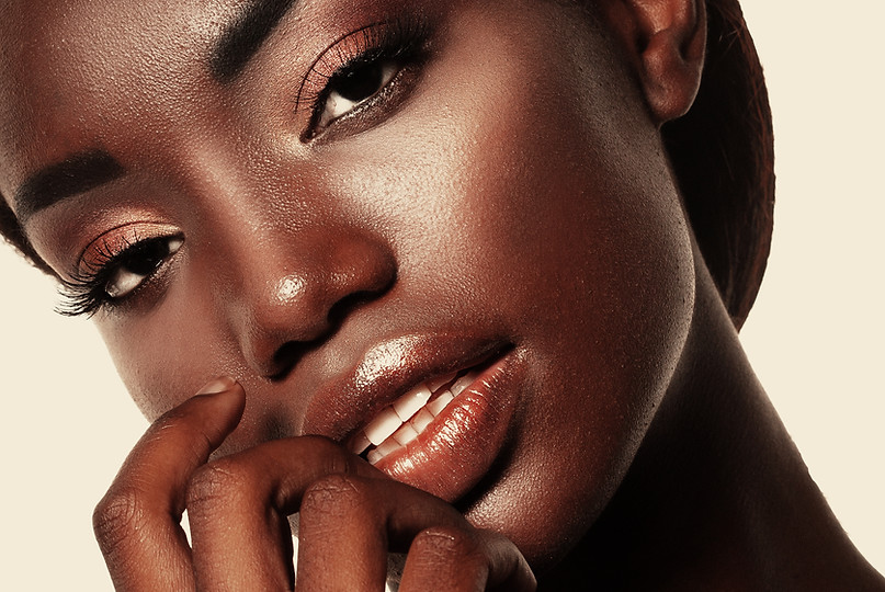 Close-up image of a black woman's face showcasing the transformative results of a microneedling treatment, emphasizing the improved texture and appearance of her skin.