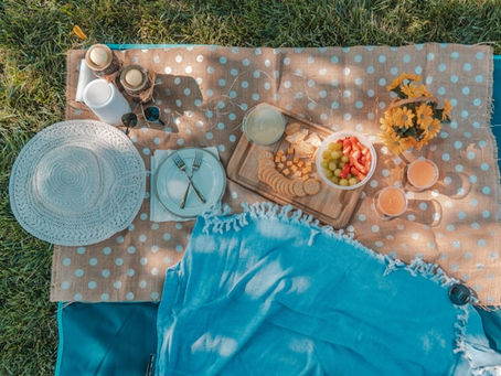 Photo of picnic spread on blanket. Sample delicious plates from local Weatherford restaurants at the Taste of Parker County event