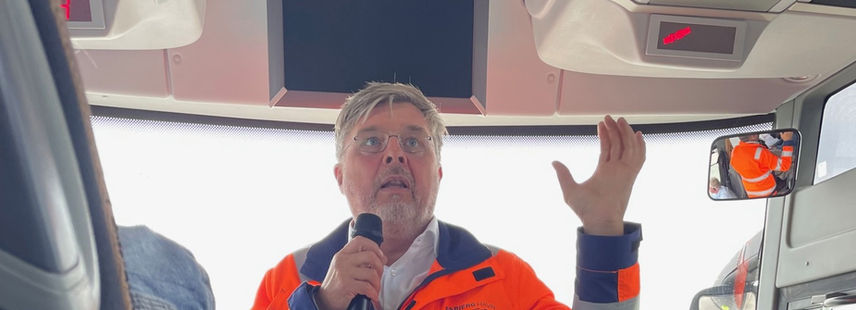 Man in safety vest with microphone