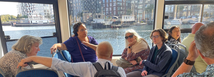 Group on a boat listening to presenter