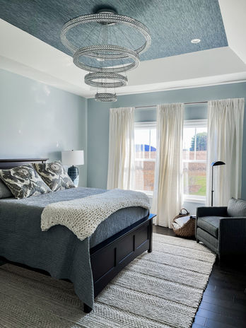 Grass Cloth ceiling in this grand master bedroom softens the look of the modern crystal chandelier.