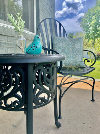 Exterior decor for home staging, black wrought iron furniture on a front porch