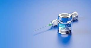 vaccine and needle, blue background