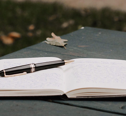 Open journal and pen outdoors — symbolizing reflection and clarity at Graceful Empowerment