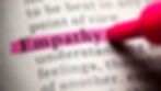 Close up shot of the word "empathy" highlighted in pink in a dictionary