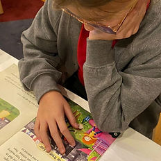 A student reading a book during a Confident Readers and Writers session.