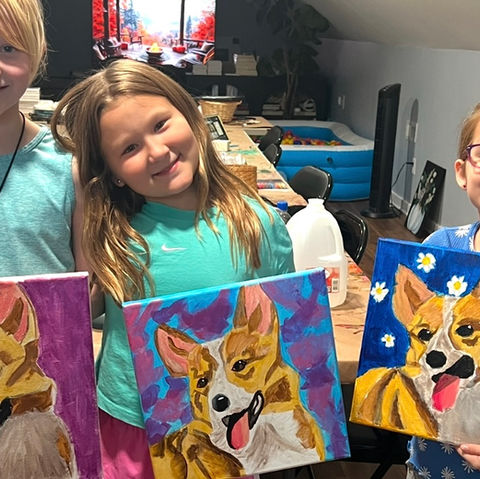 little girls showing their art work