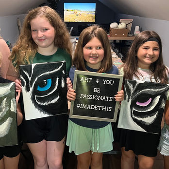 little girls showing their art work