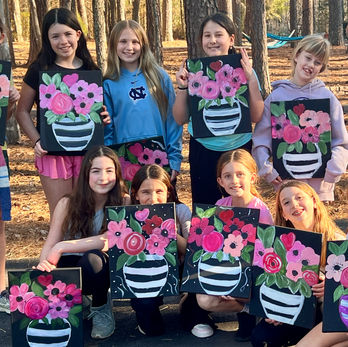 little girls showing their art work