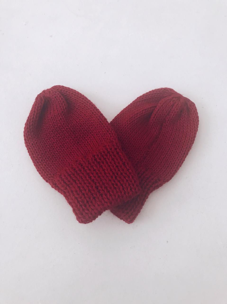 Knitted wine baby glove.