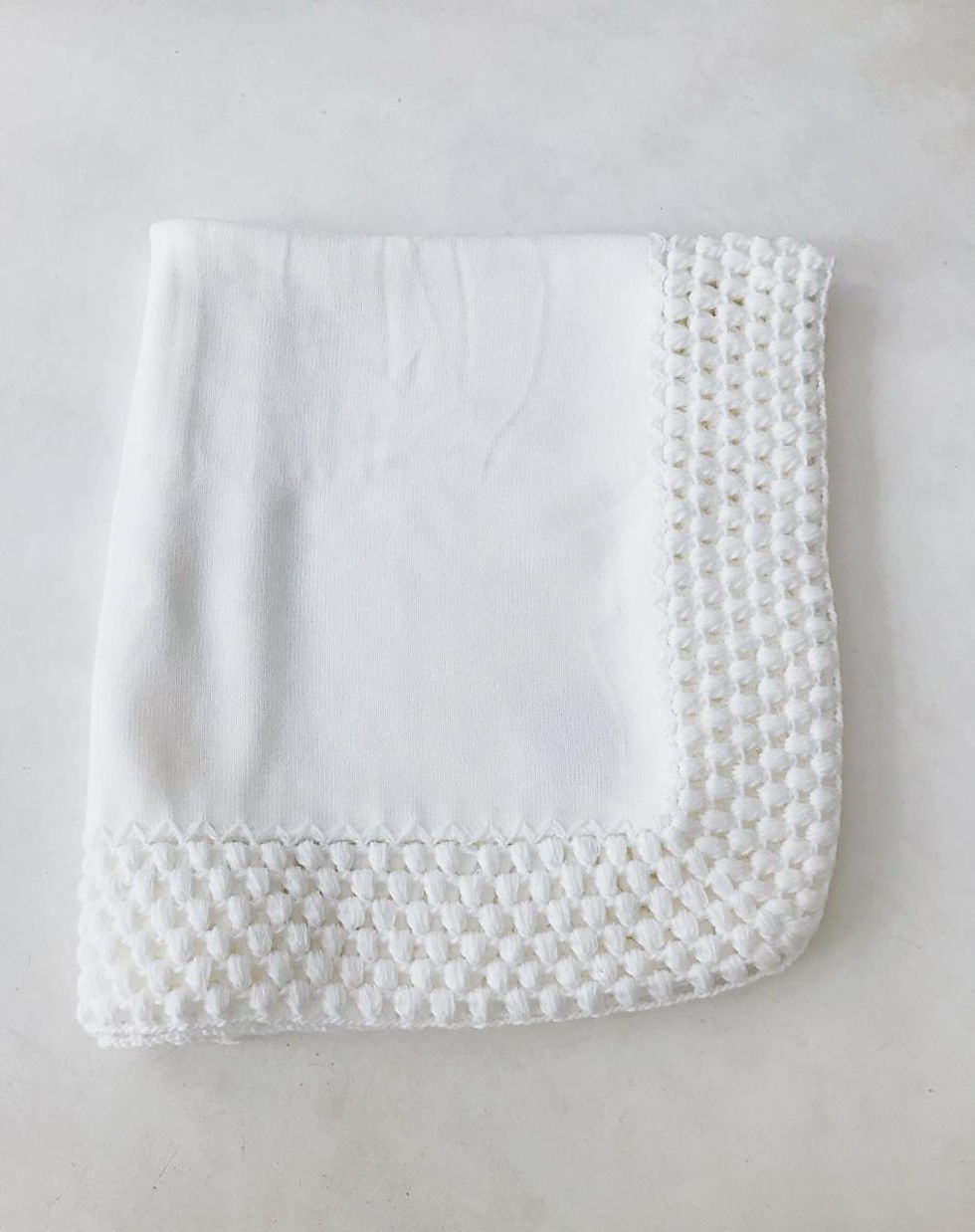 Plain white crochet blanket