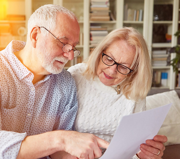 elderly couple going over papers