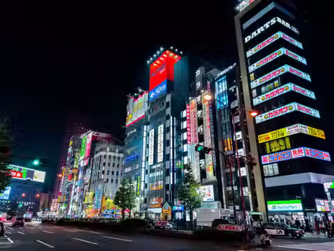 Vibrant Shinjuku street at night illuminated by neon signs and city lights, Tokyo. Explore the energy of Tokyo nightlife on an authentic private tour.