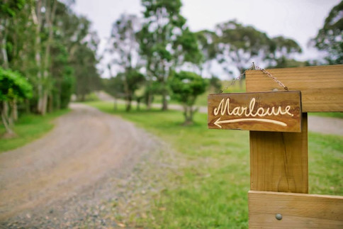 Front gate with sign saying Marlowe at Tranquilo Beach house in Woolgoolga