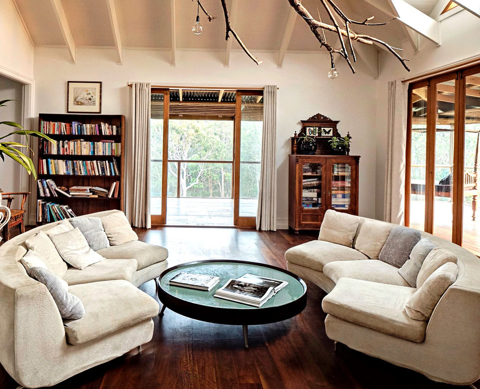 Tranquil beach house living room with curved sofas