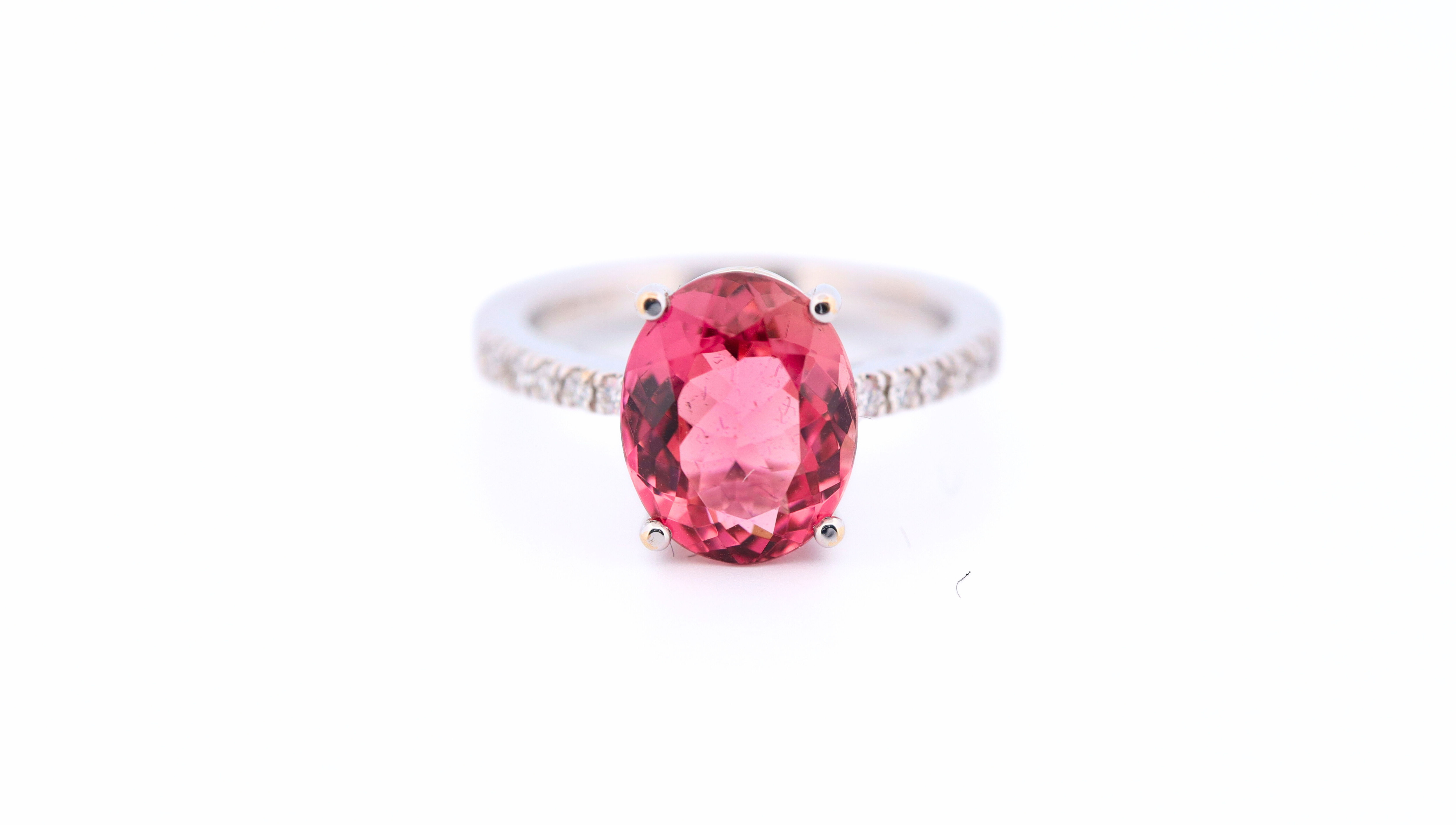 Front photo of a handmade Tourmaline Ring, sided by Diamonds, in 18k White Gold.