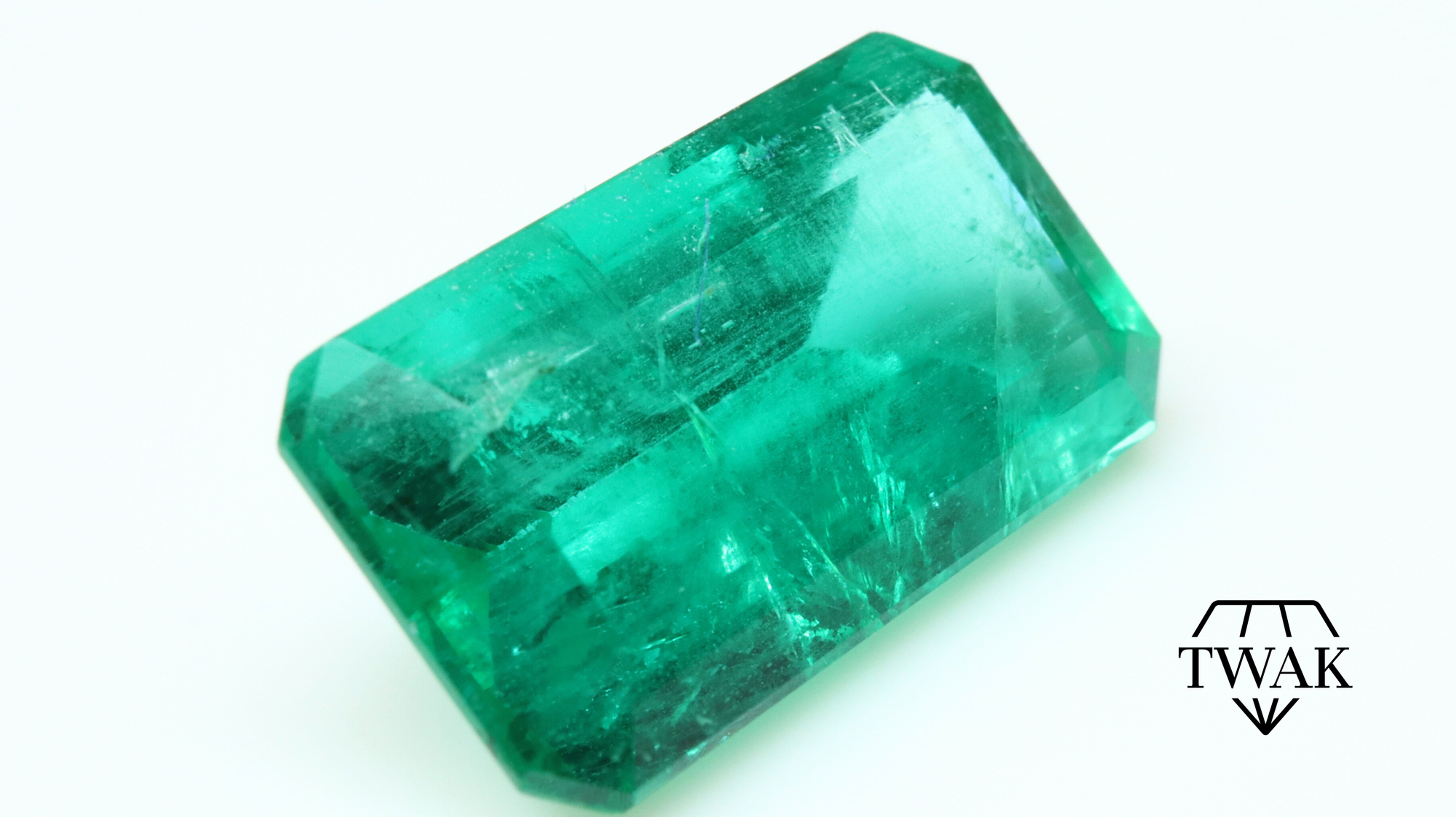 Side photo of a natural 10x6 Emerald from Brazil, with oil only.