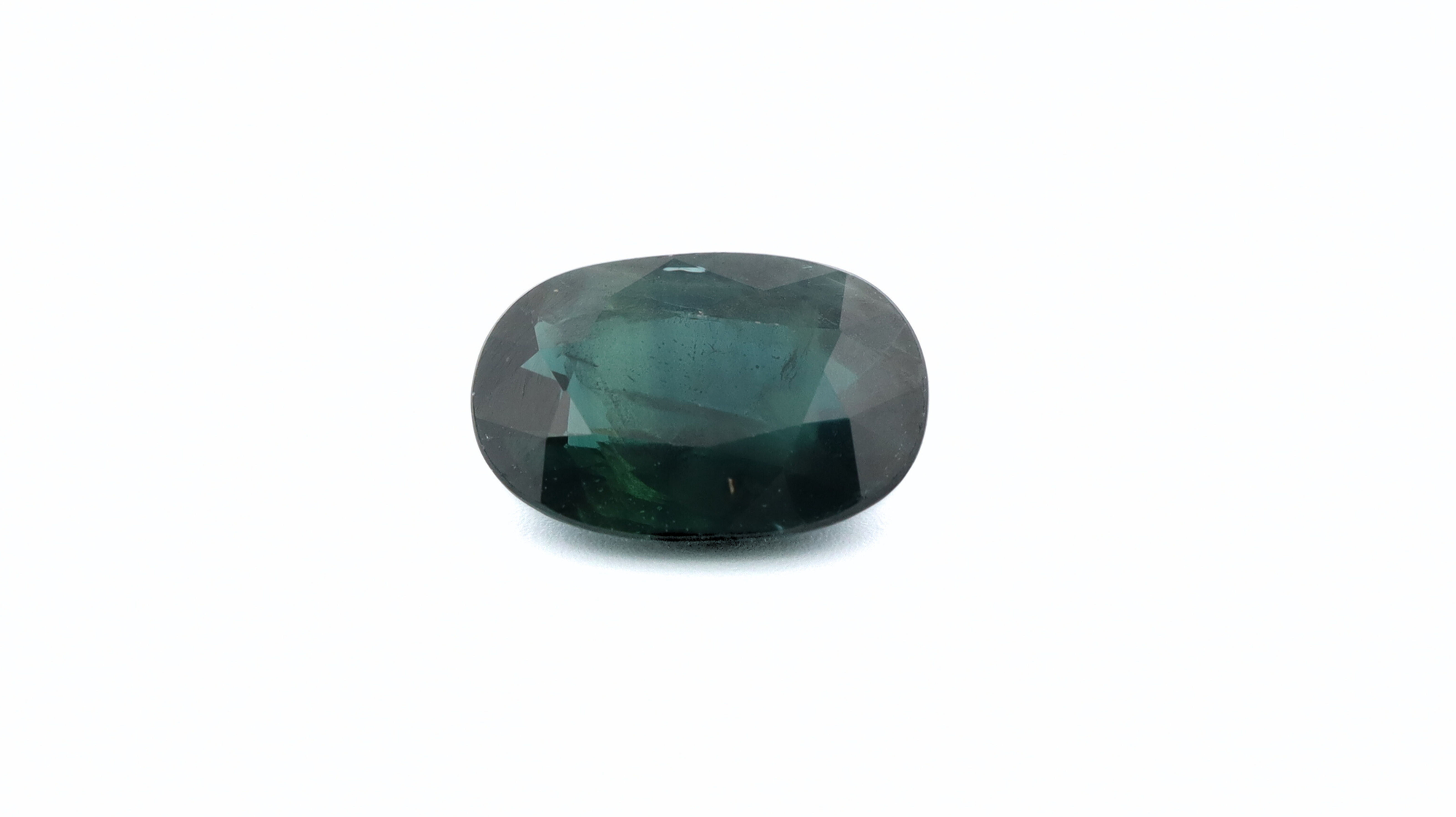 Front photo of a green Sapphire, oval cut, measuring 9.20x6.12x3.65mm and weighting 1.99ct. With a white background.