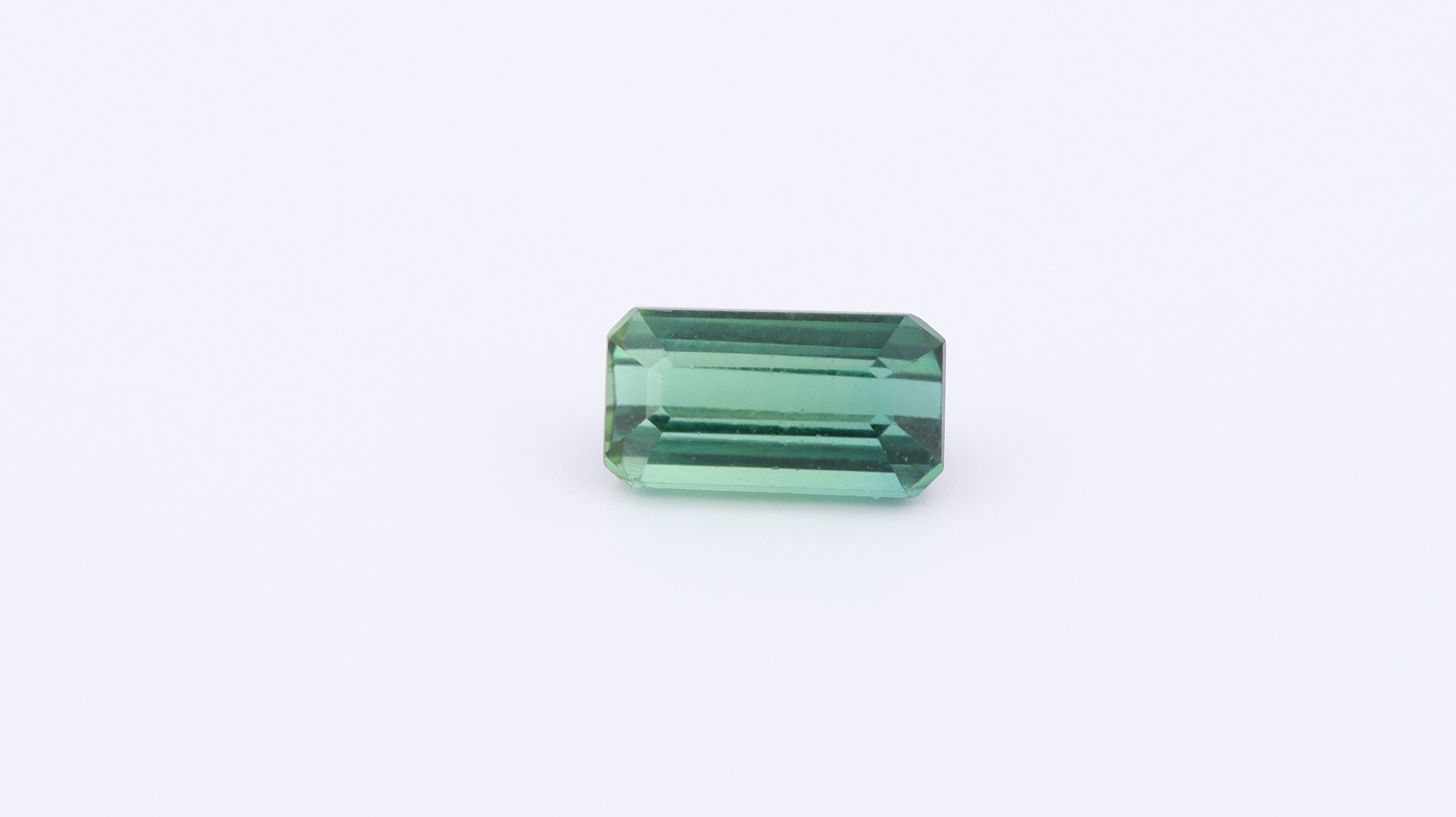 Photo of a natural Rectangular cut Green Tourmaline, measuring 6x4x4mm and weighing 1.07ct.