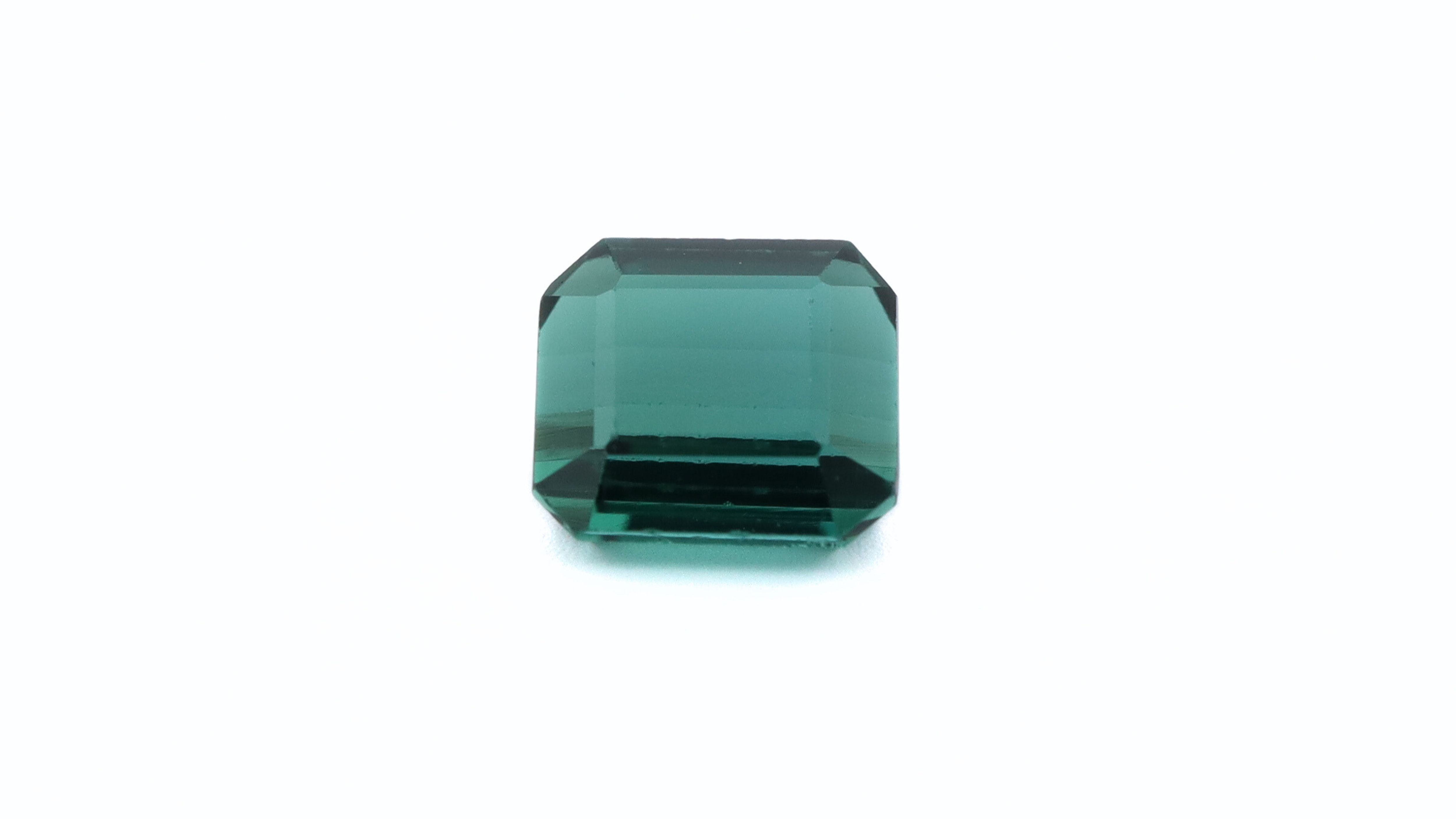 Front photo of a square cut deep green (Bluish) Tourmaline, measuring 5.53x5.07x3.31mm and weighting 0.95ct.