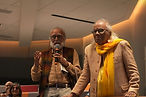 KSLF - Rahul Singh stood up in the audience holding a microphone on the left. And a gentleman stood next to him on the right.