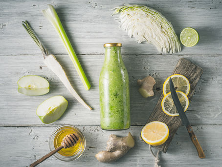 glass bottle surrounded by detox ingredients