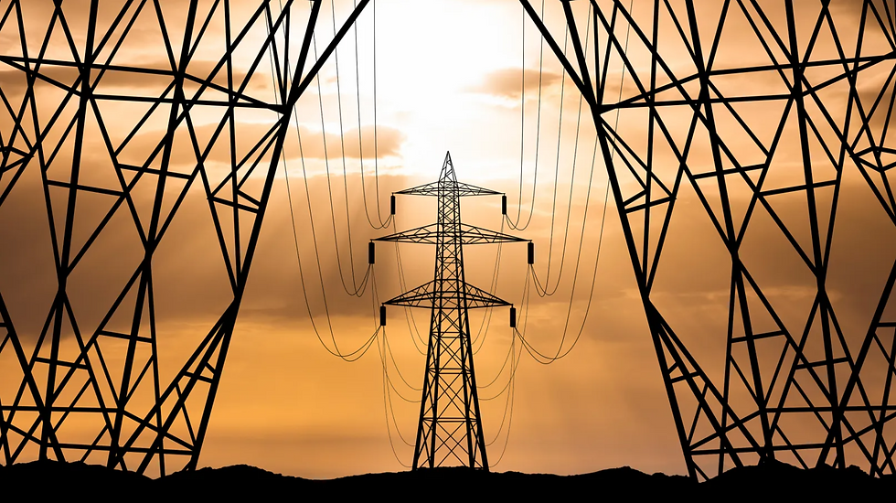 three transmission towers with a sunrise in the background