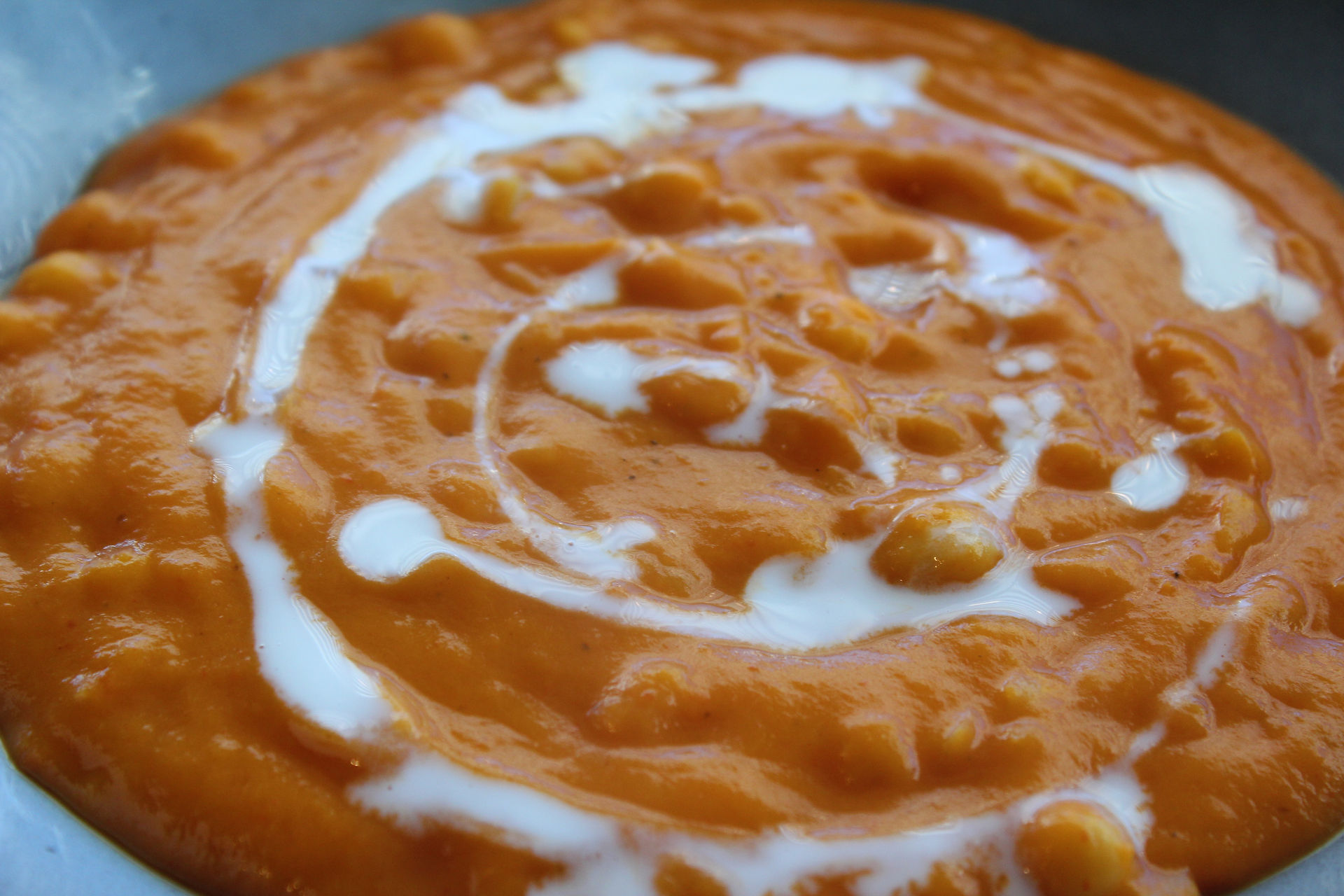 close up of soup in bowl with coconut milk circular design