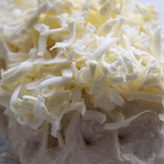 the remaining shredded butter on top of the dough before mixing in