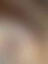 brick arch in bedroom with twin bed and pink striped headboard