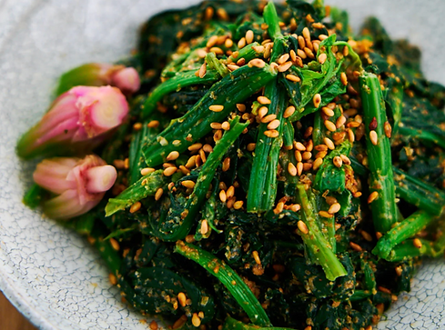 Chop the komatsuna into 10-15cm long sections, if the stems are thicker than 5cm, slice them length ways until they are roughly 1-2 cm in width. 
Drop the komatsuna into boiling water for 2 minutes if the stems are thicker, or 1 minute for thinner stems
Remove the komatsuna and shock in cold (preferably iced) water for 30 seconds, then spread out on a rack or tea towel to drain and dry fully. 
Toast the sesame seeds until browned and fragrant. 
Add the sugar, chillies and sesame seeds to a mortar and grind until the sesame seeds break down slightly.
Slowly add soy sauce and rice wine vinegar/sake to taste for the desired balance of salty, sweet, and umami .
Combine the komatsuna and dressing, tossing as a salad. Traditionally, Goma Ae is served as individual side dishes rather than as a large communal salad. 