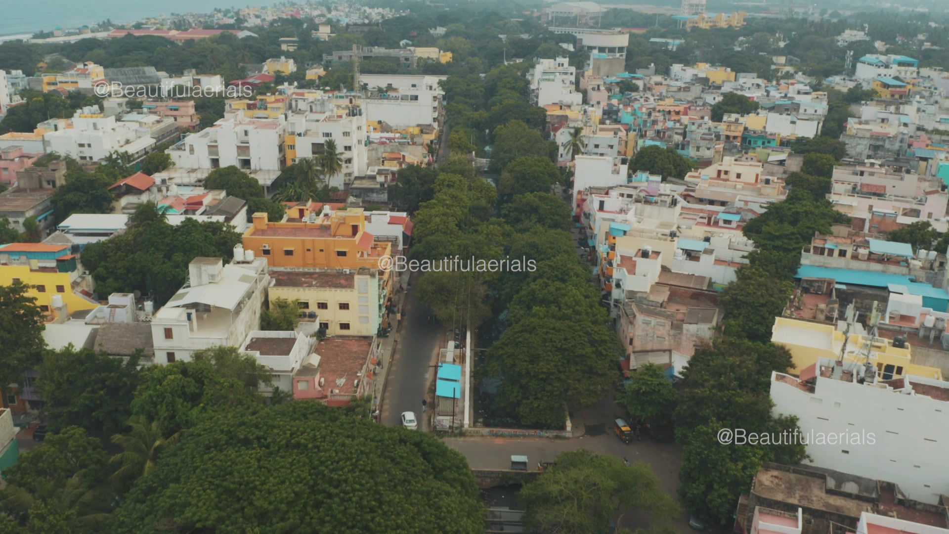 Car reveal shot overlooking an aerial view of Pondicherry city in India