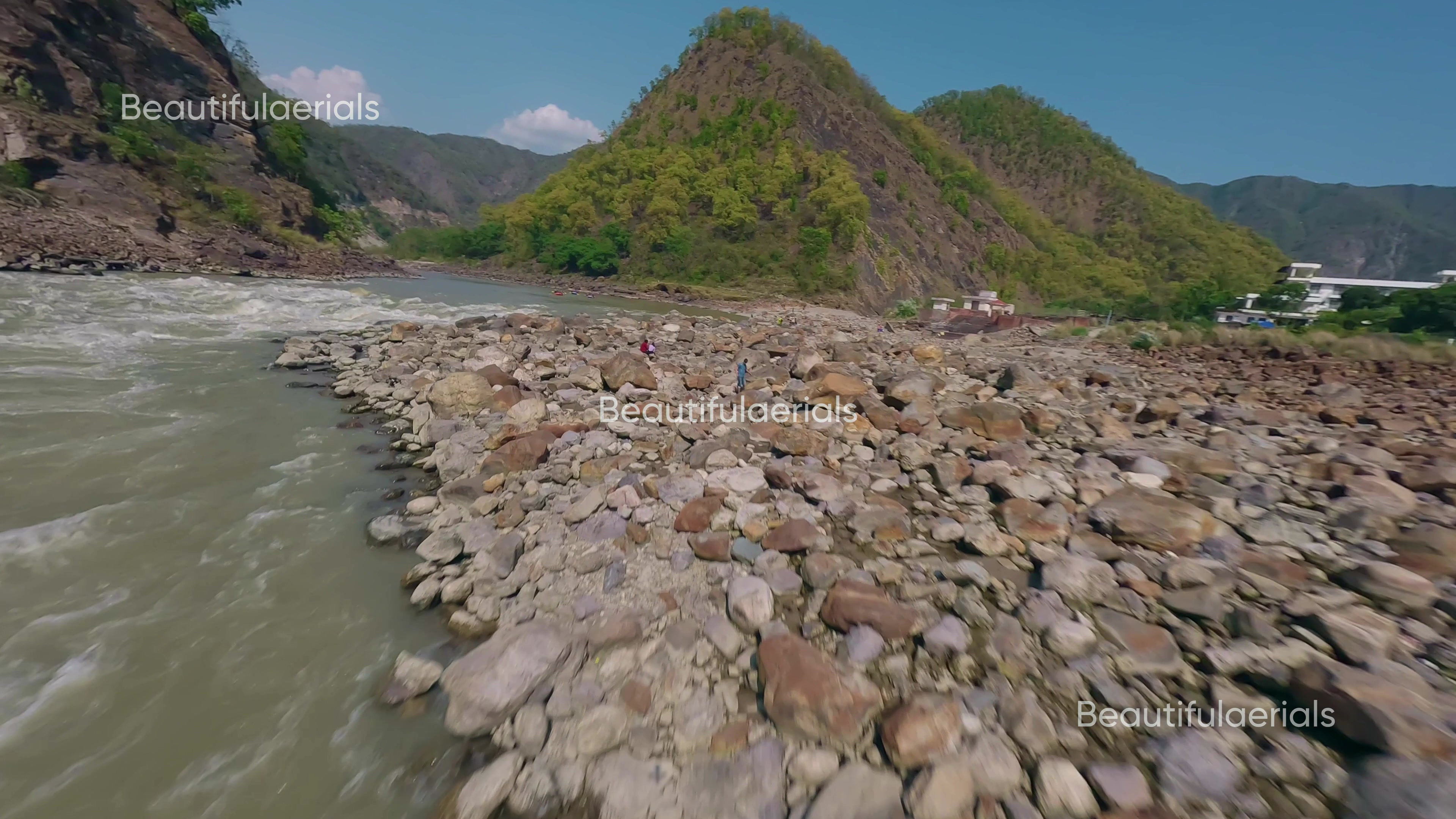 Beautiful sunny FPV shot of rafting with mountain backdrop in Rishikesh, Uttrakh
