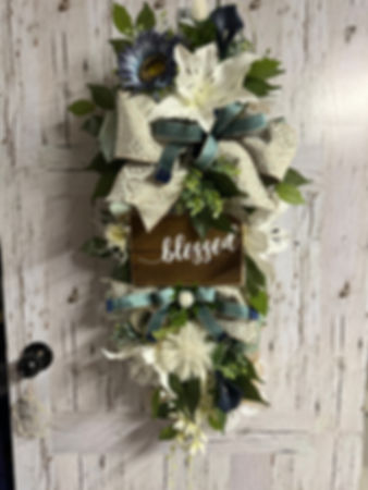 Mint and white door swag.   Tiger lilies,   Blue sunflower,   Dandelion pompom