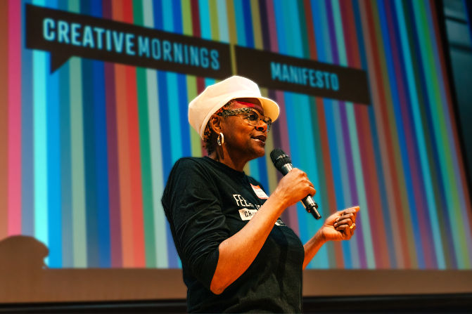 Lachandra Baker speaking on stage at a CreativeMornings event